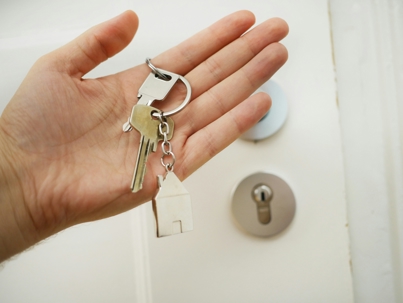 person holding keys to house